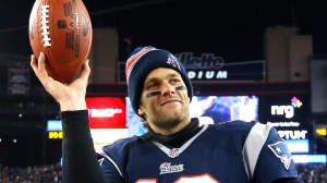 New England Patriots quarterback Tom Brady holds up the game ball after an NFL divisional playoff football game against the Baltimore RavensSaturday, Jan. 10, 2015, in Foxborough, Mass. The Patriots won 35-31 to advance to the AFC Championship game. (AP Photo/Elise Amendola) ORG XMIT: NYDP181