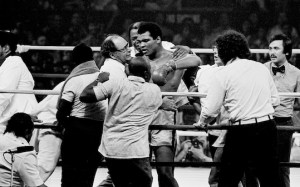 Muhammad Ali is in the ring surrounded by his trainers, handlers and doctors after winning in the 14th round against Joe Frazier at the Coiseum in Manila, Oct. 1, 1975. (AP Photo)