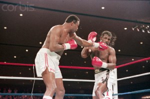 19 Apr 1986, Las Vegas, Nevada, USA --- 4/19/1986-Las Vegas, Nevada-: Larry Holmes punching Michael Spinks during their rematch fight for the heavyweight championship.  Spinks won the 15-round fight on a decision to retain his I.B.F. crown. --- Image by © Bettmann/CORBIS