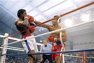 LAS VEGAS, NV - JANUARY 24, 1976:  George Forman (R) throws a punch to the head of Ron Lyles (L) during a Heavyweight elimination fight January 24, 1976 at Caesars Palace in Las Vegas, Nevada. Forman KO'd Lyles in the 5th round. (Photo by Focus On Sport/Getty Images)