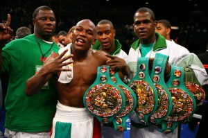 LAS VEGAS - MAY 05: Floyd Mayweather Jr. (M) celebrates his split decision victory against Oscar De La Hoya with two members of his camp after their WBC super welterweight championship fight at the MGM Grand Garden Arena May 5, 2007 in Las Vegas, Nevada. (Photo by Al Bello/Getty Images) *** Local Caption *** Floyd Mayweather Jr.