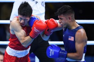 Aug 9, 2016; Rio de Janeiro, Brazil; Daisuke Narimatsu (JPN, red gloves) competes with  JR. Carlos Zenon Balderas (USA, blue gloves) during the men's light preliminaries in the Rio 2016 Summer Olympic Games at Riocentro - Pavilion 6. Mandatory Credit: Jack Gruber-USA TODAY Sports