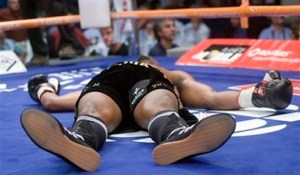 Joachim Alcine, of Canada, lies on the canvas after a sixth round knockout by Daniel Santos, of Puerto Rico, during their WBA light middleweight title fight Friday, July 11, 2008, in Montreal. (AP Photo/The Canadian Press, Ryan Remiorz)