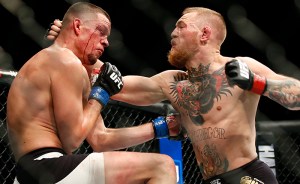 Nate Diaz, left, trades punches Conor McGregor during their UFC 196 welterweight mixed martial arts match, Saturday, March 5, 2016, in Las Vegas.  Diaz won by submission in the second round. (AP Photo/Eric Jamison)
